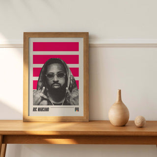 Roc Marciano poster in frame on wooden shelf, showcasing sleek wordplay and artistry.