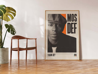 Mos Def museum-quality poster in matte paper displayed under a chair.