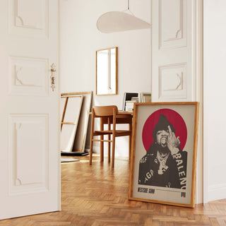 Westside Gunn poster in a stylish modern room, showcasing black and white halftone imagery with a colored background, framed, leaned against a wall.