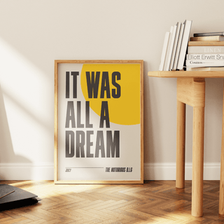 Notorious B.I.G. "Juicy" lyrics poster on thick matte paper, unframed, displayed near a wooden table.