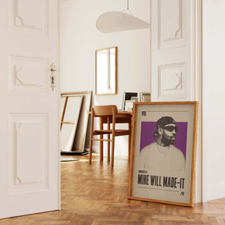 Mike WiLL Made-It poster in frame on the floor of a stylish room.