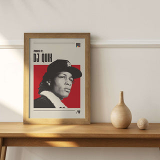 Poster of DJ Quik in a wood frame on a shelf, featuring museum-quality matte paper.