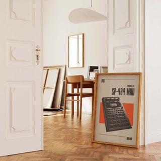 Roland SP-404 MK2 museum-quality poster in wooden frame on matte paper, displayed in elegant room setting.