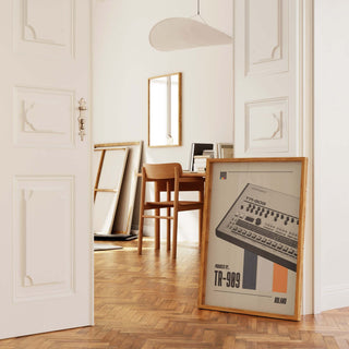 TR-909 poster in a stylish interior workspace, showcasing its iconic role in electronic music.