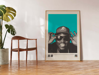 Big Boi poster featuring vibrant design, available in multiple sizes, displayed beside a chair.