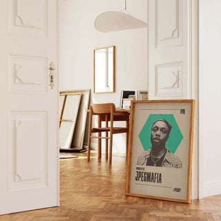 JPEGMAFIA poster in a wooden frame, displayed in a stylish, sunlit room with minimalistic decor.