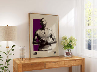 Rakim poster displayed on a wooden table, highlighting his legacy in hip-hop.